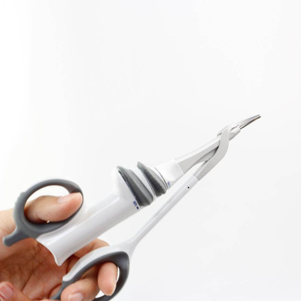 Hand holding ultrasonic shears with scissor-style ring controls